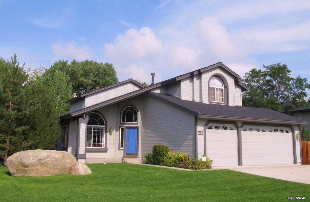 14415 Ghost Rider Drive Reno, NV 89511 - Photo 1 of 1 a front view of a house with a yard and trees
