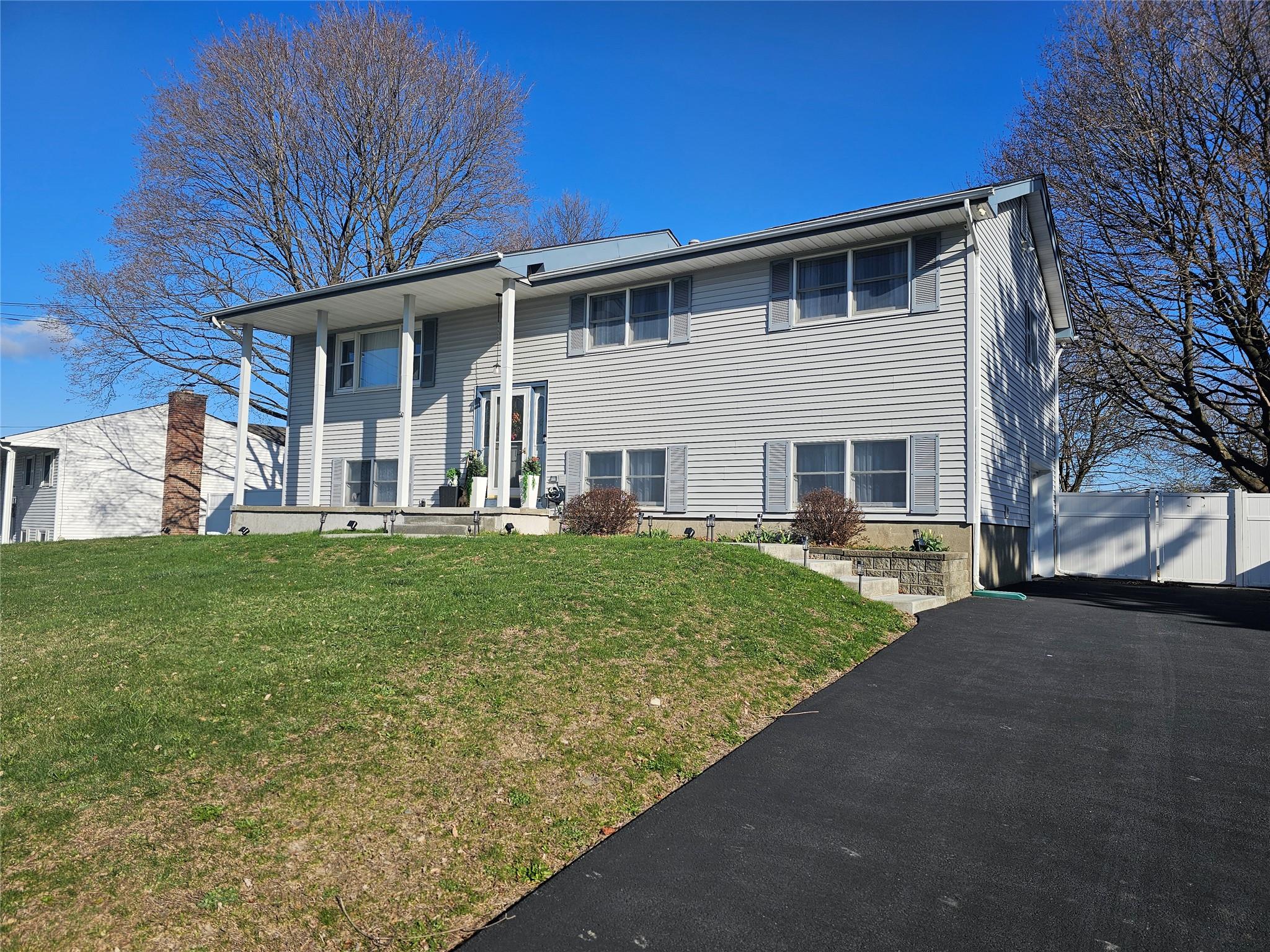 a front view of a house with a yard and porch