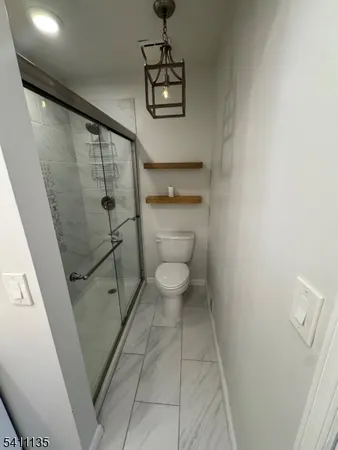 a bathroom with a toilet and a shower