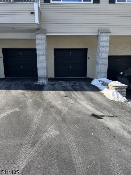 50 West Lindsley Road, Unit 42 Cedar Grove, NJ 07009 - Photo 23 of 26 a front view of a house with a yard and a garage