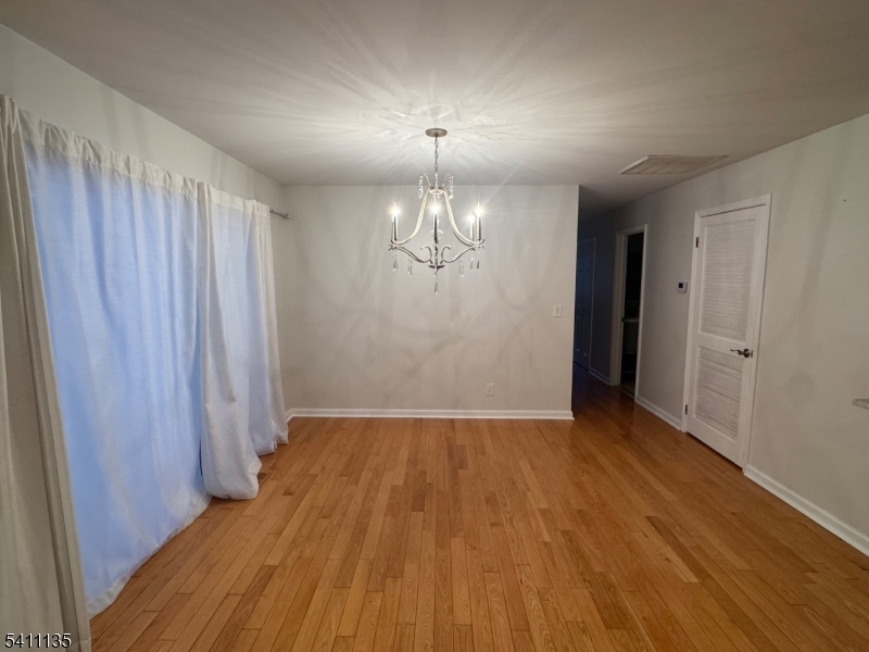 50 West Lindsley Road, Unit 42 Cedar Grove, NJ 07009 - Photo 6 of 26 wooden floor in an empty room with a window