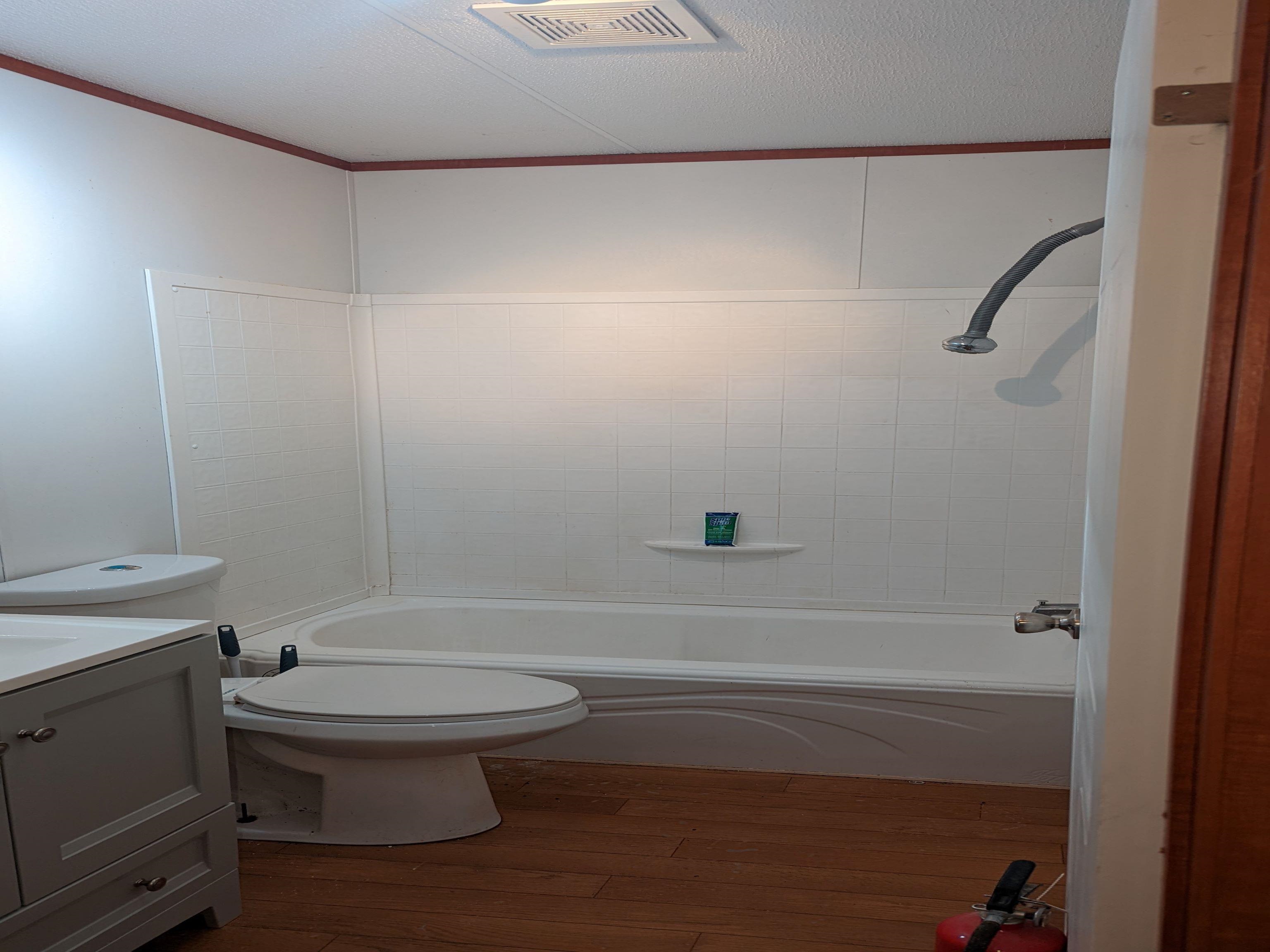 793 Robertson Road Mason, TN 38049 - Photo 16 of 23 a bathroom with a toilet and a shower