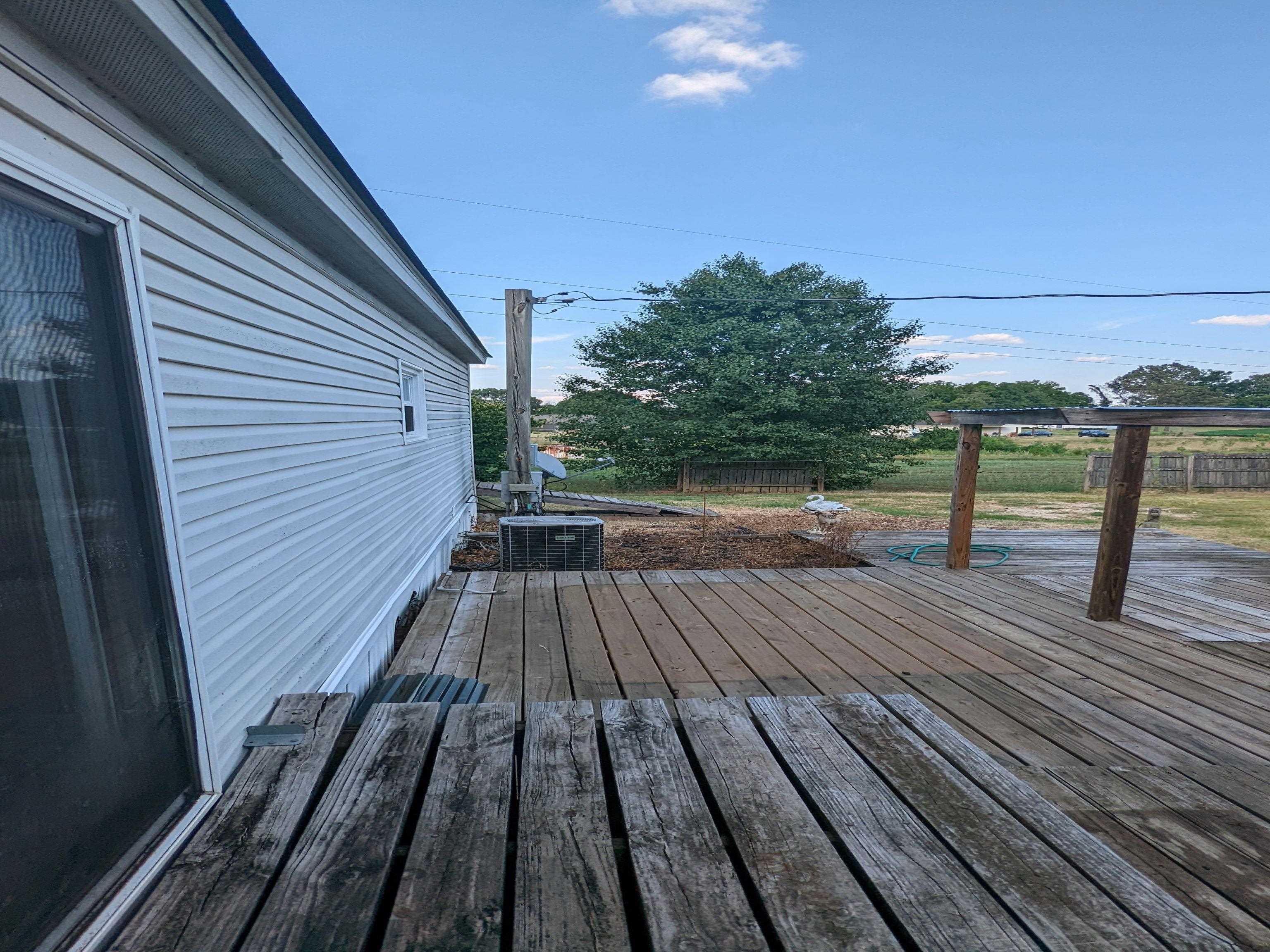 793 Robertson Road Mason, TN 38049 - Photo 18 of 23 a view of deck with wooden floor and outdoor seating