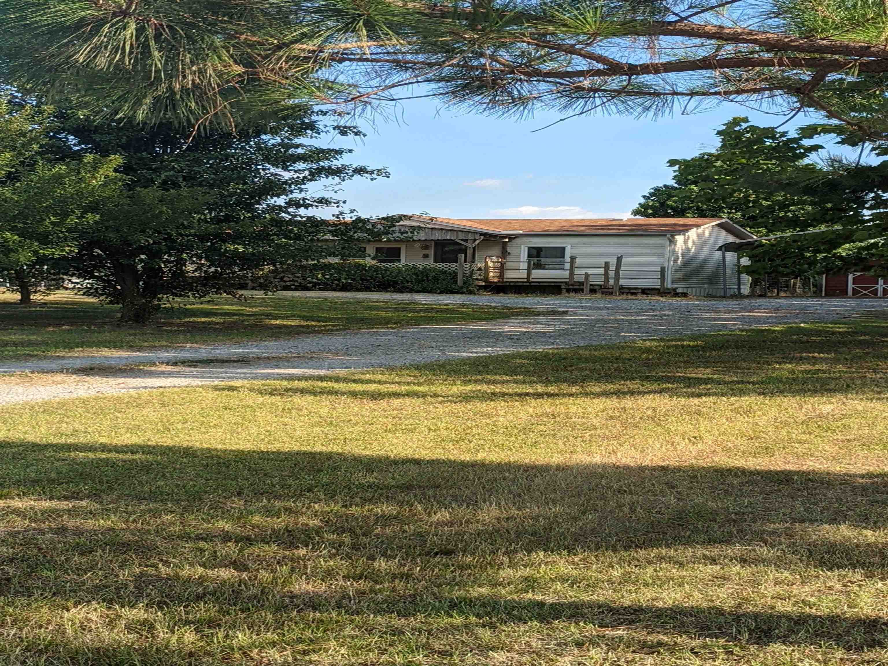 793 Robertson Road Mason, TN 38049 - Photo 3 of 23 a view of a swimming pool with lawn chairs under an umbrella