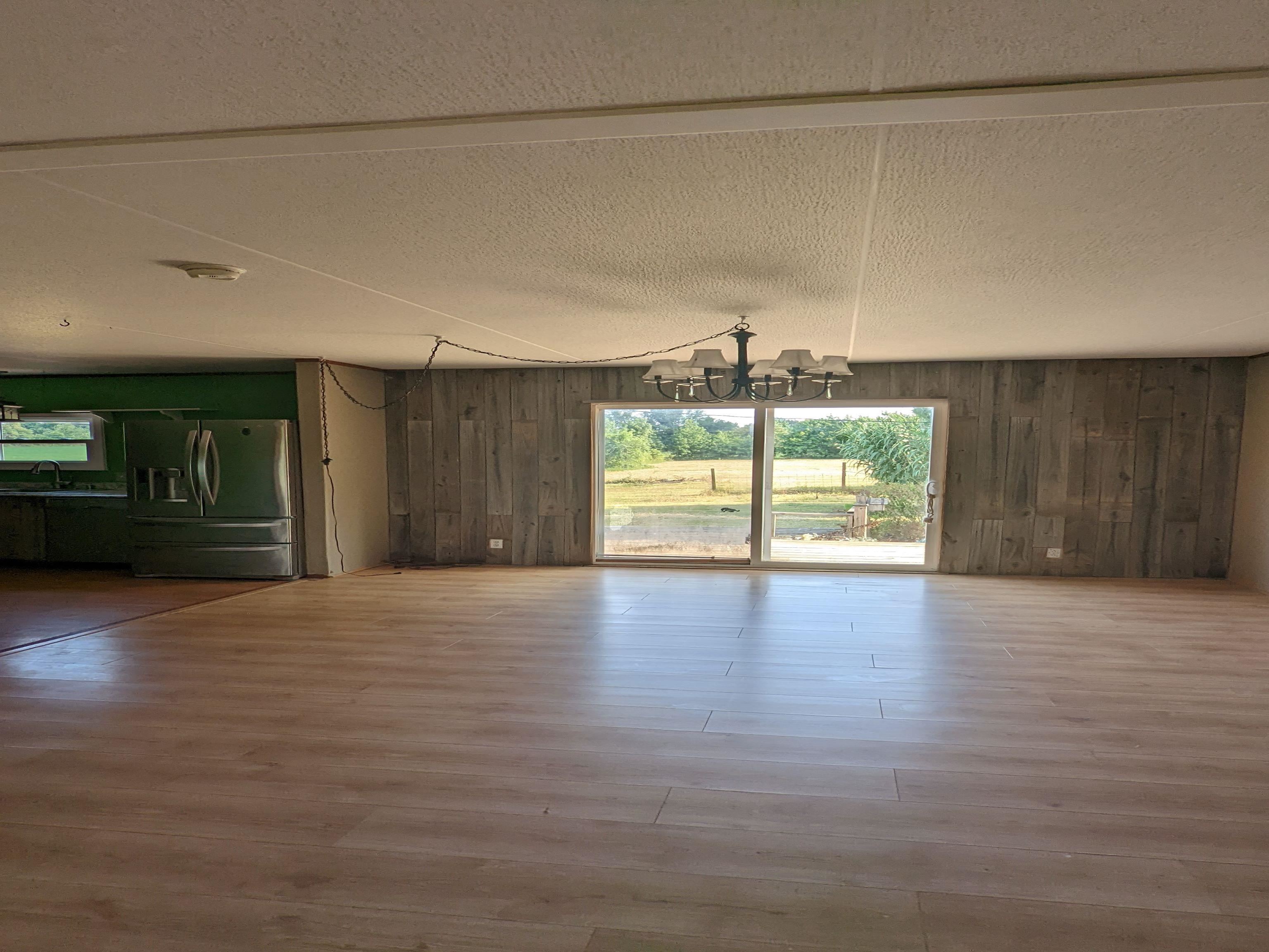 793 Robertson Road Mason, TN 38049 - Photo 5 of 23 a view of an empty room with a window and wooden floor