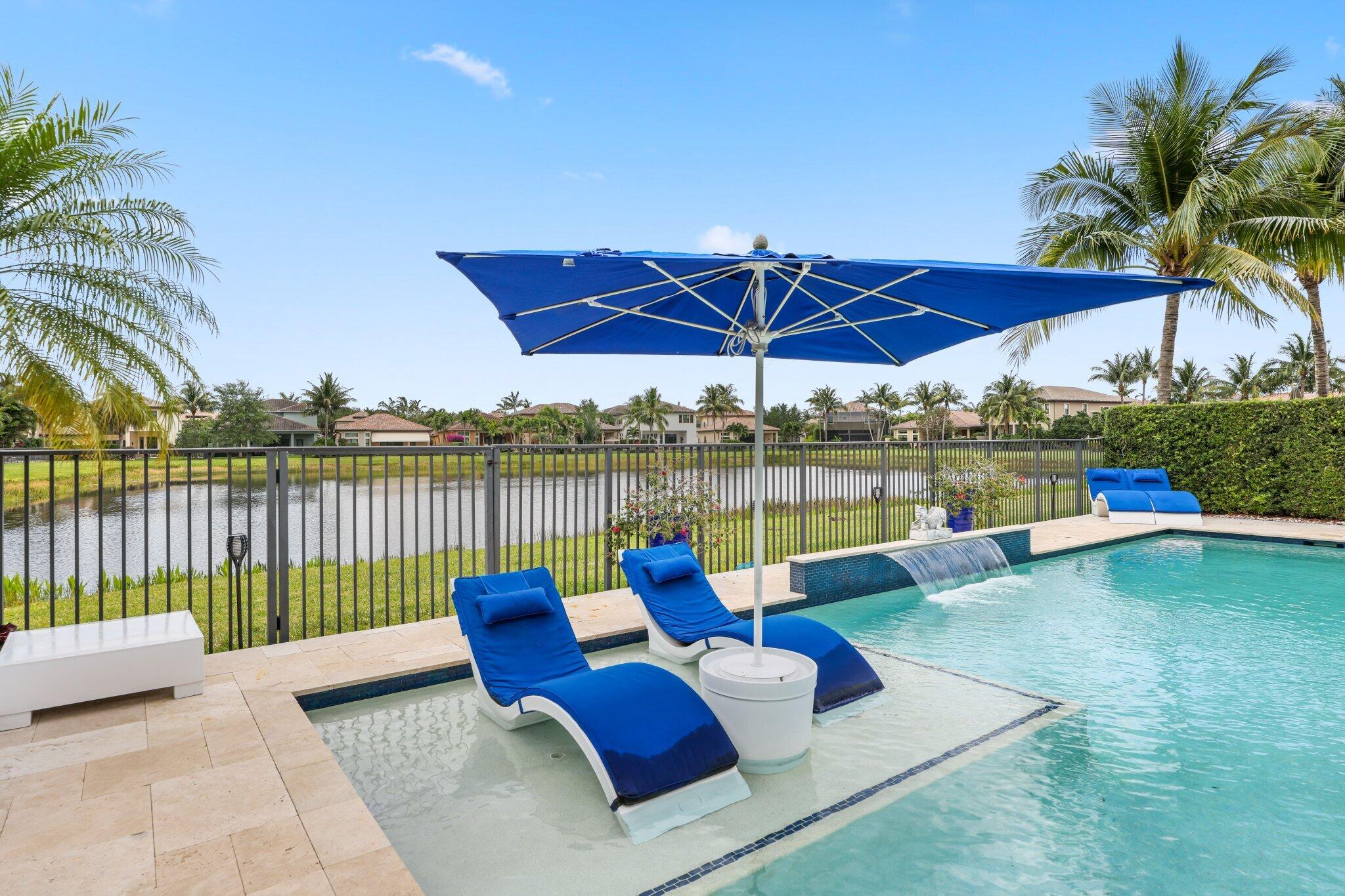 a view of a patio with couches chairs under an umbrella