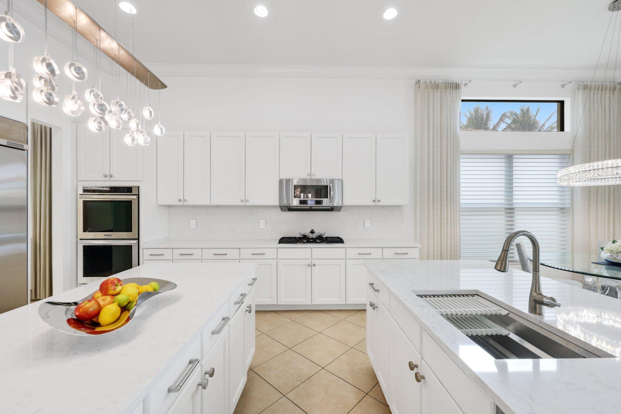 8539 Lewis River Road Delray Beach, FL 33446 - Photo 13 of 49 a kitchen with stainless steel appliances granite countertop a sink a stove and a wooden cabinets