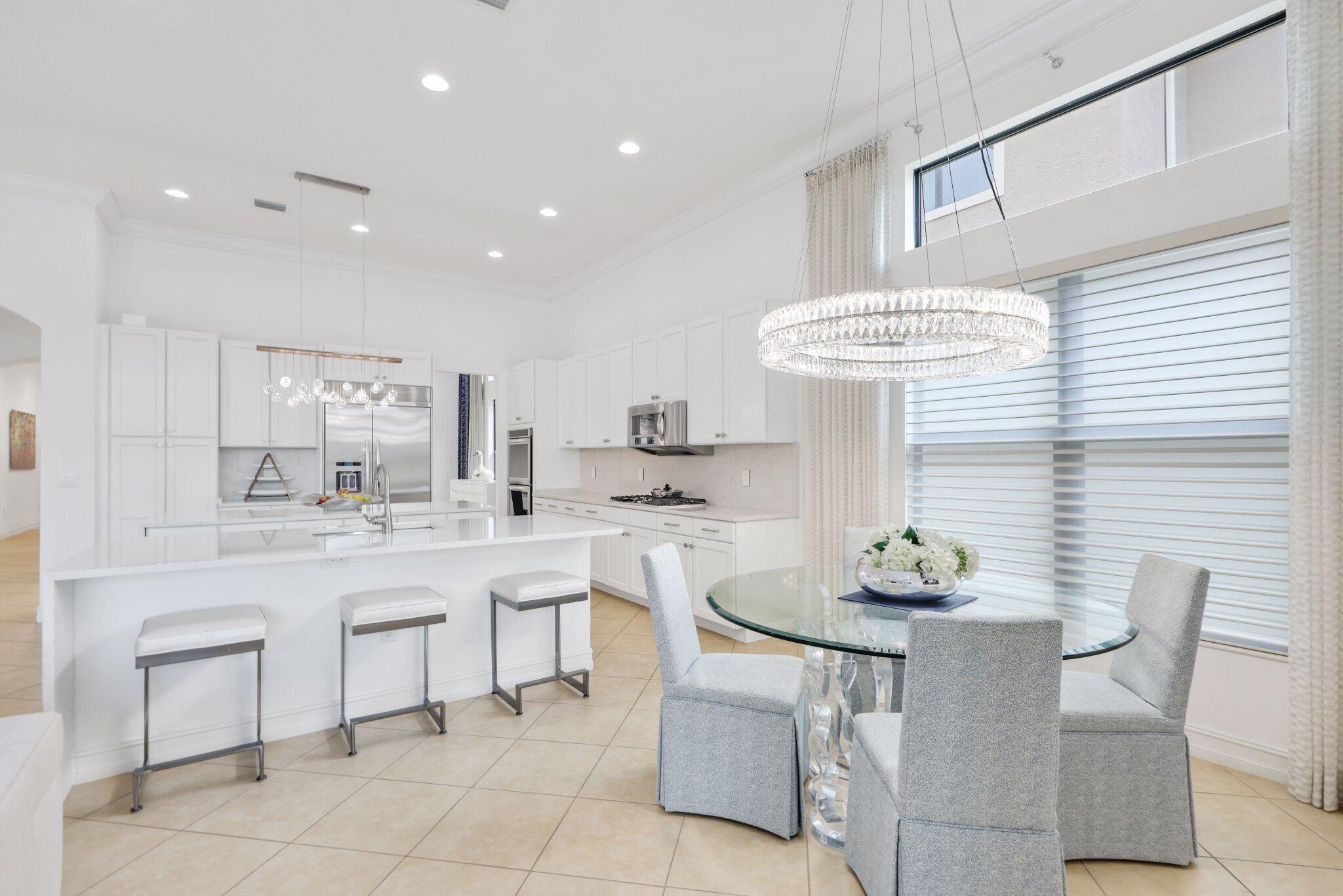 8539 Lewis River Road Delray Beach, FL 33446 - Photo 16 of 49 a kitchen with a table and chairs in it