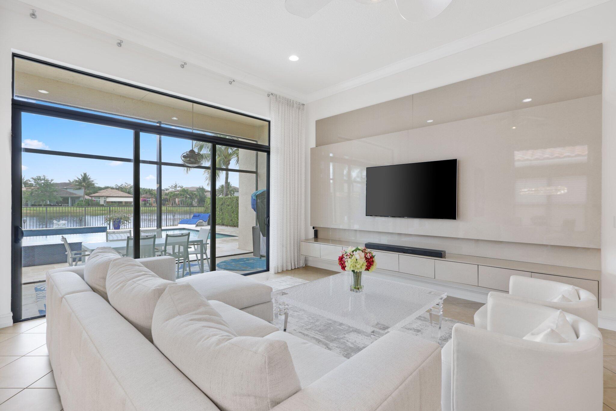 8539 Lewis River Road Delray Beach, FL 33446 - Photo 20 of 49 a living room with furniture and a flat screen tv
