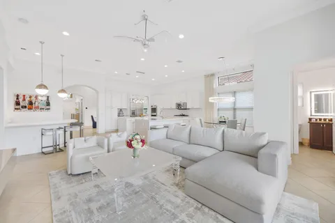 a living room with furniture and kitchen view