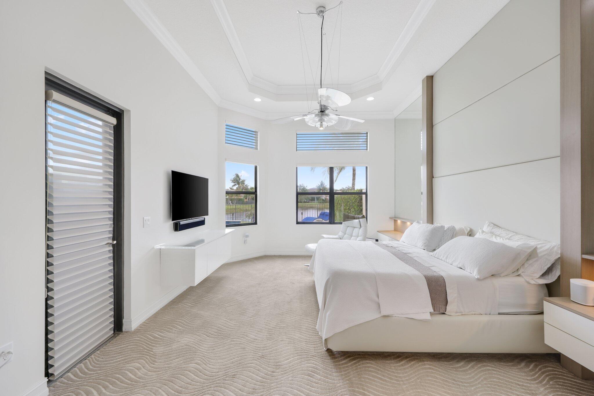 8539 Lewis River Road Delray Beach, FL 33446 - Photo 25 of 49 a bedroom with a bed and a flat screen tv