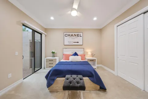 a bed room with a bed and a large mirror