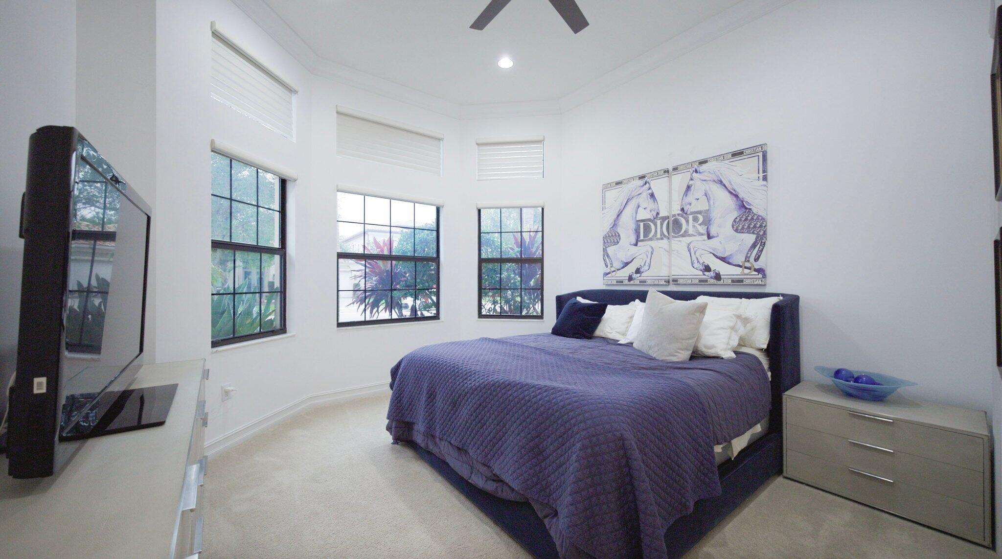 8539 Lewis River Road Delray Beach, FL 33446 - Photo 32 of 49 a bedroom with a large bed and a flat tv screen on a dresser