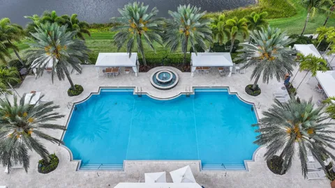 an aerial view of a house with a yard and outdoor seating