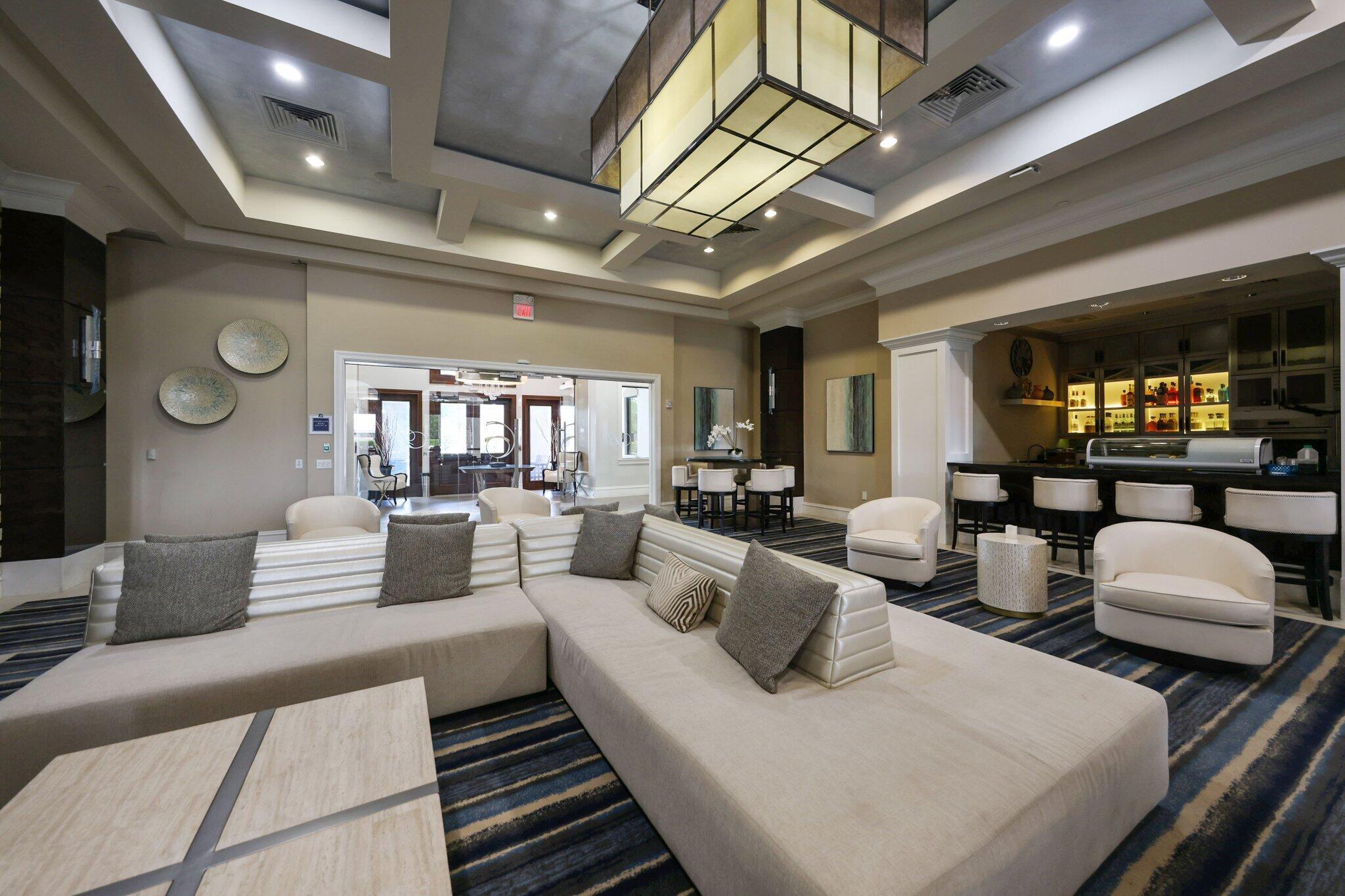 8539 Lewis River Road Delray Beach, FL 33446 - Photo 47 of 49 a living room with furniture and a chandelier