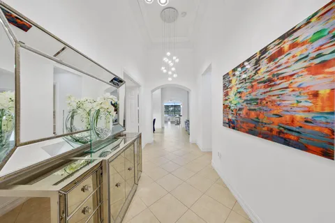 a view of a hallway to a livingroom with furniture