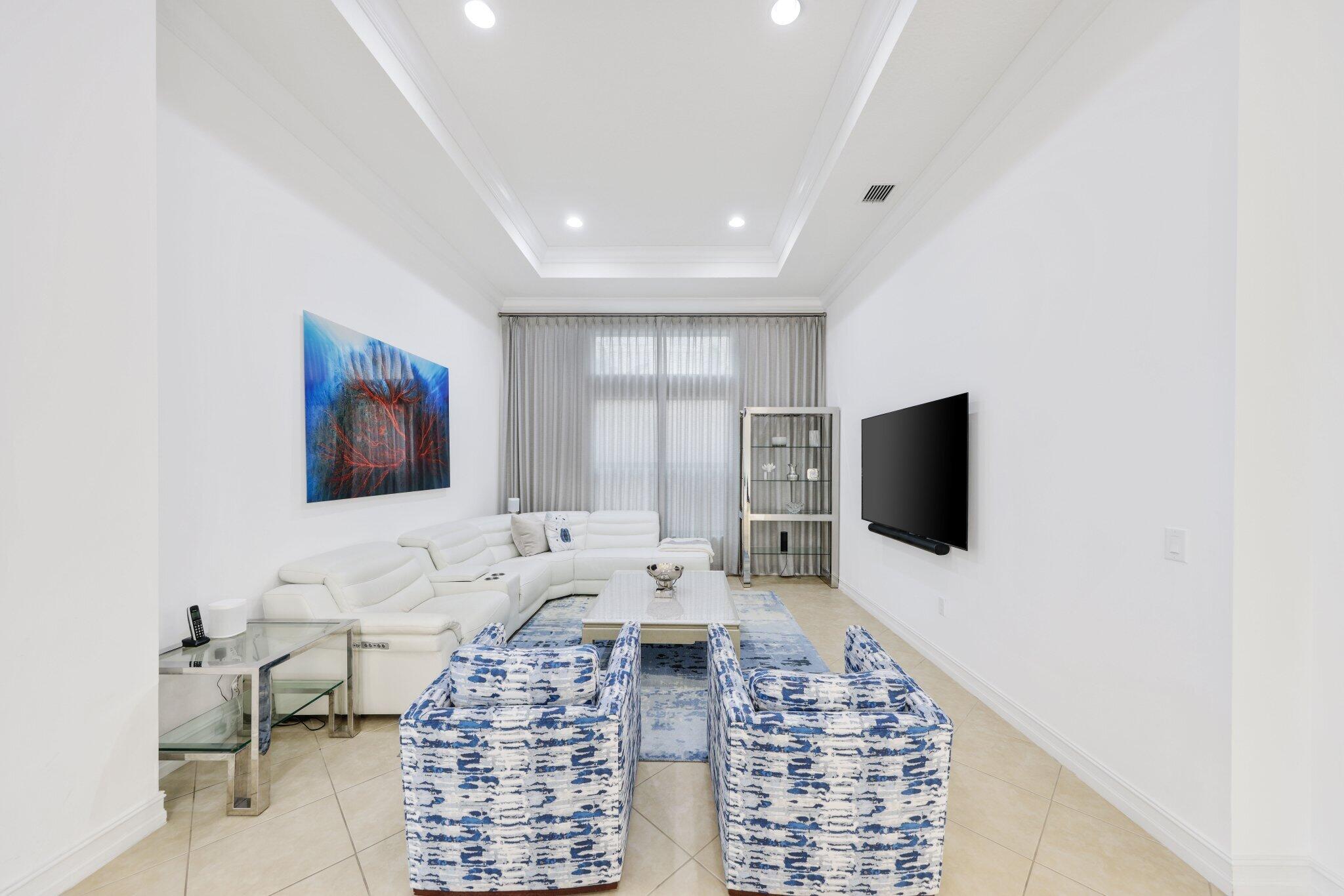 8539 Lewis River Road Delray Beach, FL 33446 - Photo 8 of 49 a living room with furniture and a flat screen tv