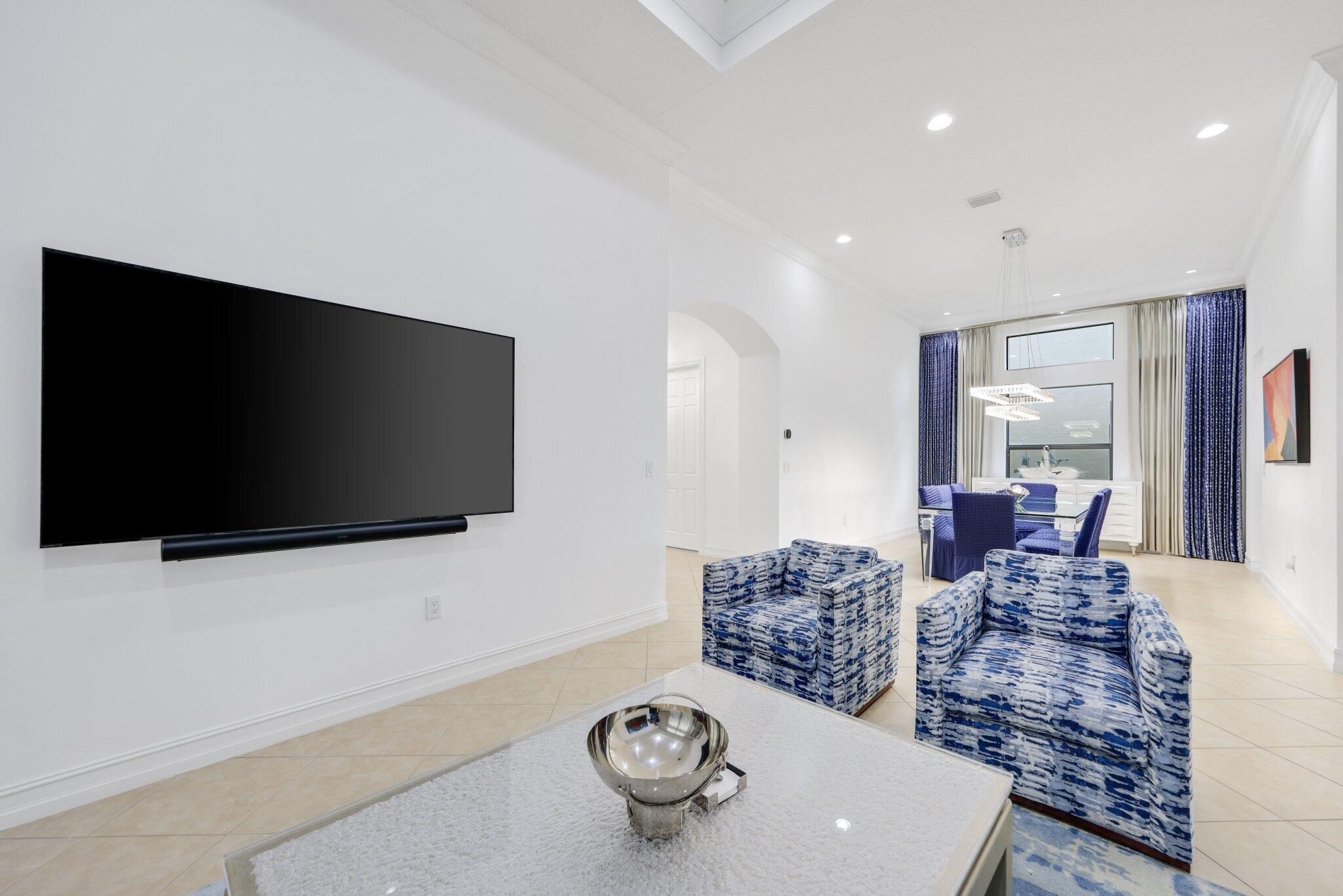 8539 Lewis River Road Delray Beach, FL 33446 - Photo 9 of 49 a living room with furniture and a flat screen tv