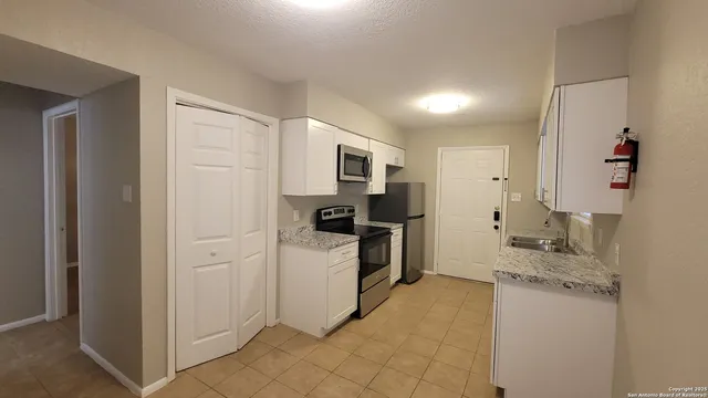 a kitchen with a sink microwave and refrigerator