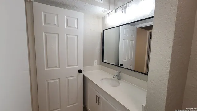a bathroom with a sink and mirror