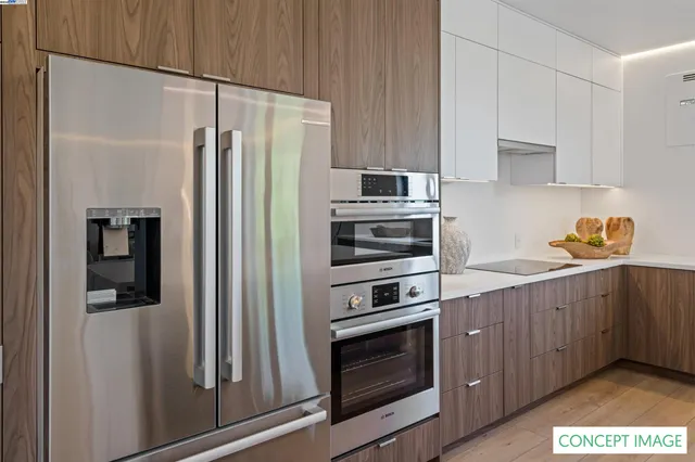 a kitchen with appliances a refrigerator and cabinets