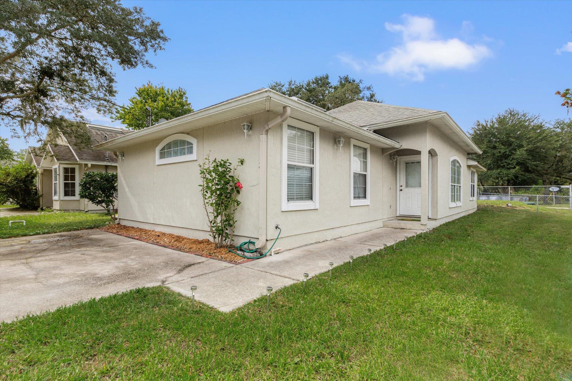a front view of a house with a garden