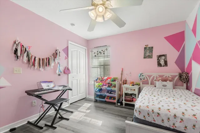 a bedroom with furniture and a chair