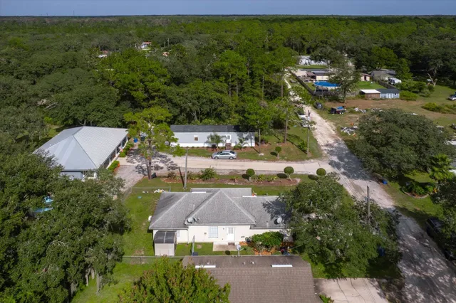 an aerial view of residential houses with outdoor space and street view