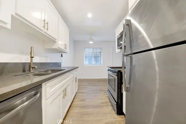 a bathroom with a granite countertop sink a toilet and shower