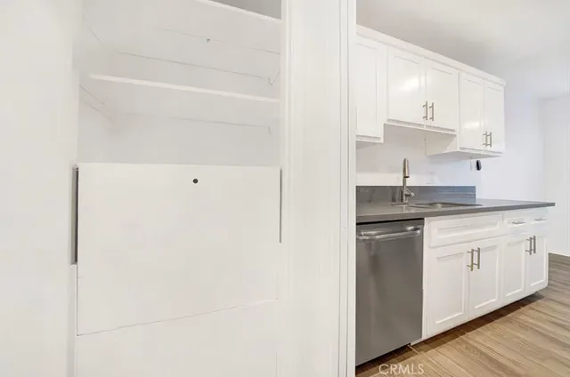 a kitchen with a sink window and cabinets