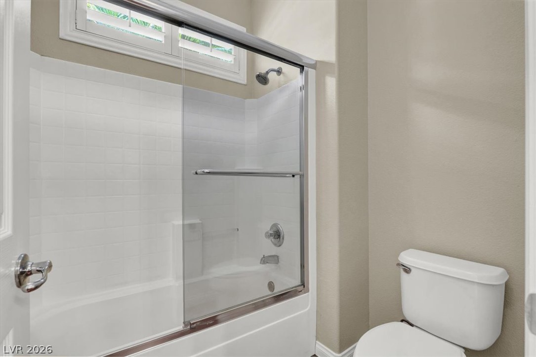 7308 Rustic Meadow Street Las Vegas, NV 89131 - Photo 16 of 27 A well-appointed bath features a sparkling shower/tub combination with a sleek glass enclosure.