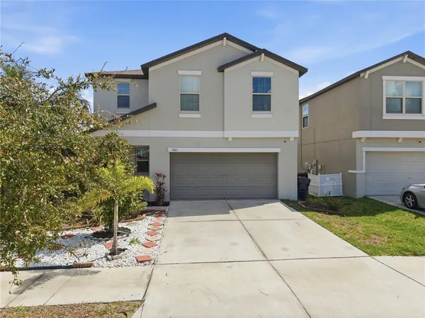 a front view of a house with yard
