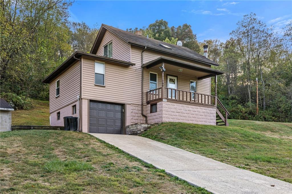 2381 Highway 18 Clinton, PA 15026 - Photo 2 of 27 a front view of a house with a garden