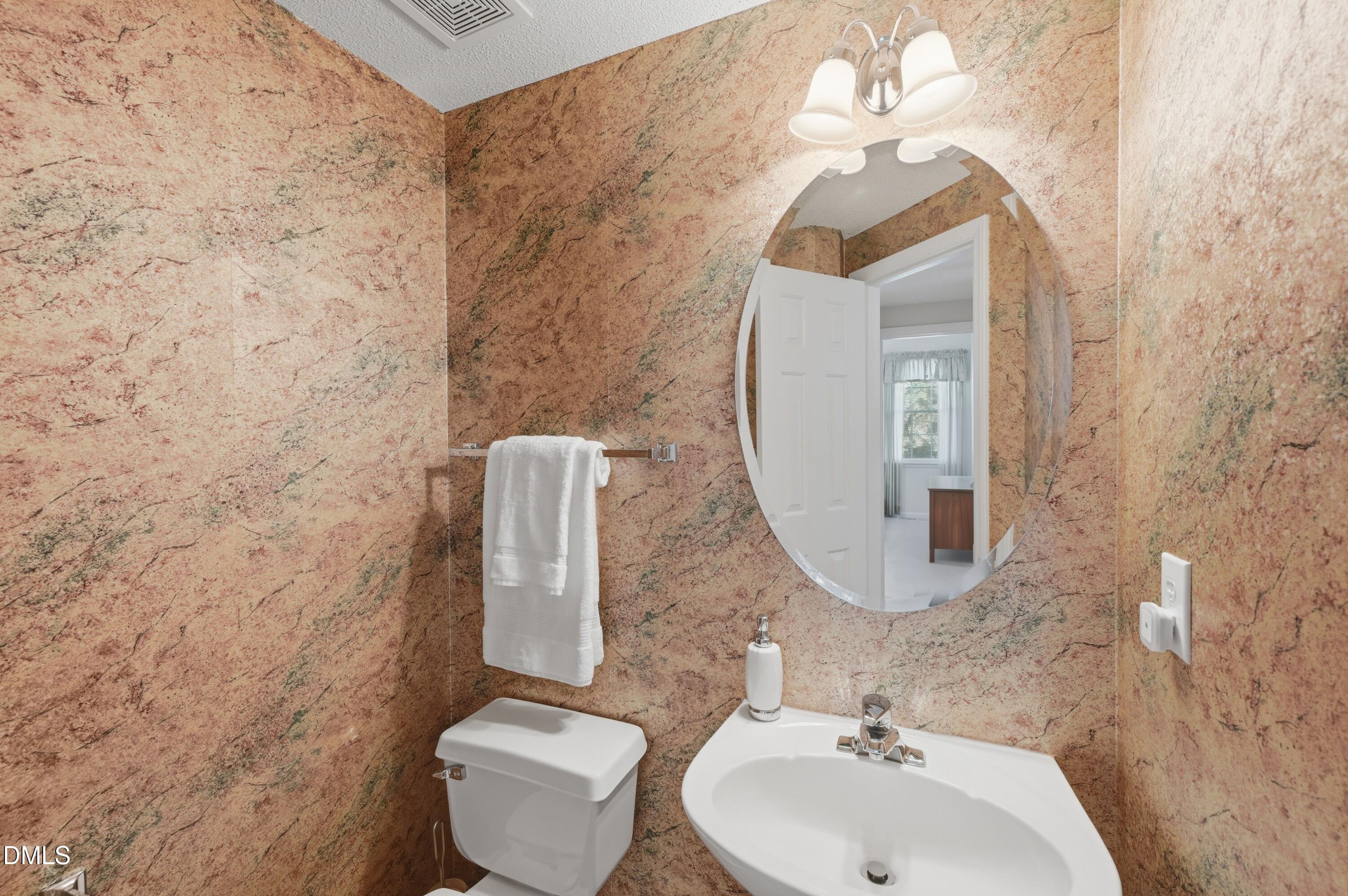 6801 Lynnoak Drive Raleigh, NC 27613 - Photo 13 of 30 a bathroom with a toilet sink and mirror