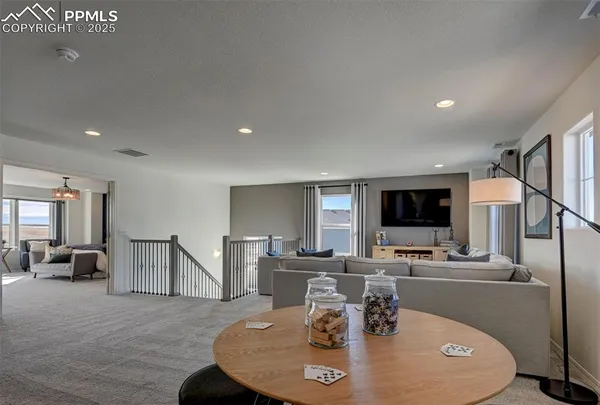 a dining room with furniture and a flat screen tv