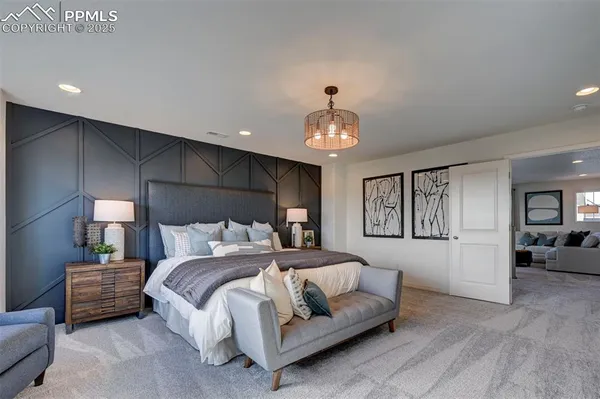 a bedroom with a bed and a chandelier