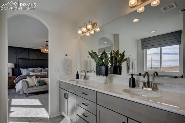 a bathroom with a double vanity sink and a mirror