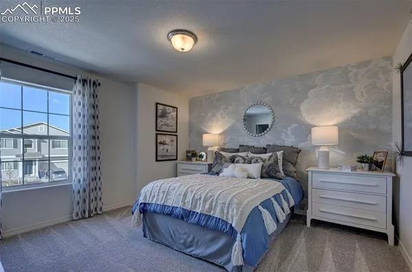 a bedroom with a bed and window