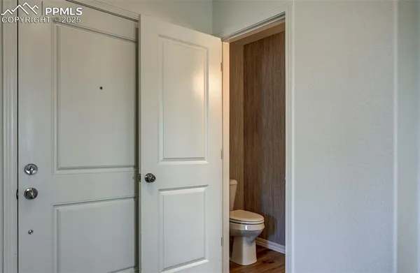 a bathroom with a toilet and a shower