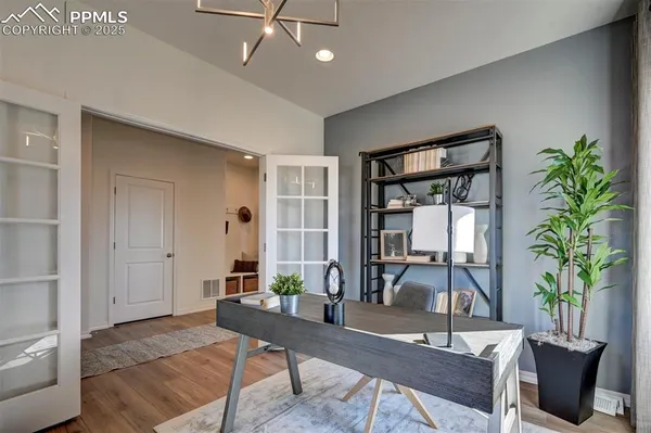 a living room with furniture a potted plant and a table