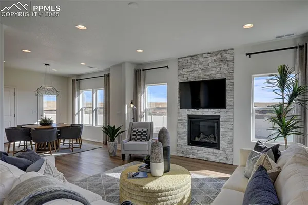 a living room with furniture a fireplace and a flat screen tv