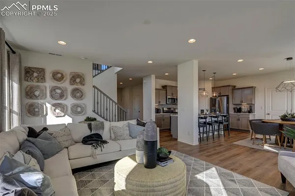 a living room with furniture and wooden floor