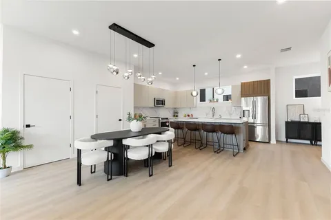 a view of a dining room with furniture and wooden floor