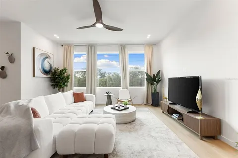 a bedroom with furniture and a large window