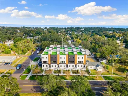 an aerial view of residential houses with outdoor space and street view
