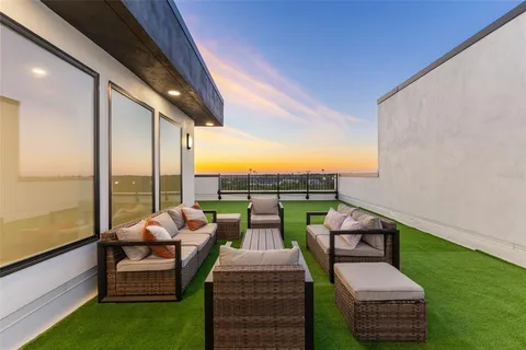 a balcony with chairs and a table