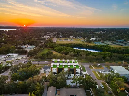 an aerial view of residential houses with outdoor space and parking