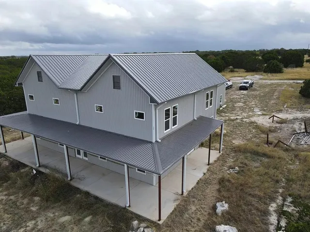 a house with tall trees in the background