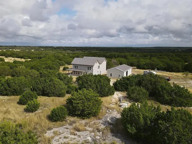 a view of a garden with a building in the background