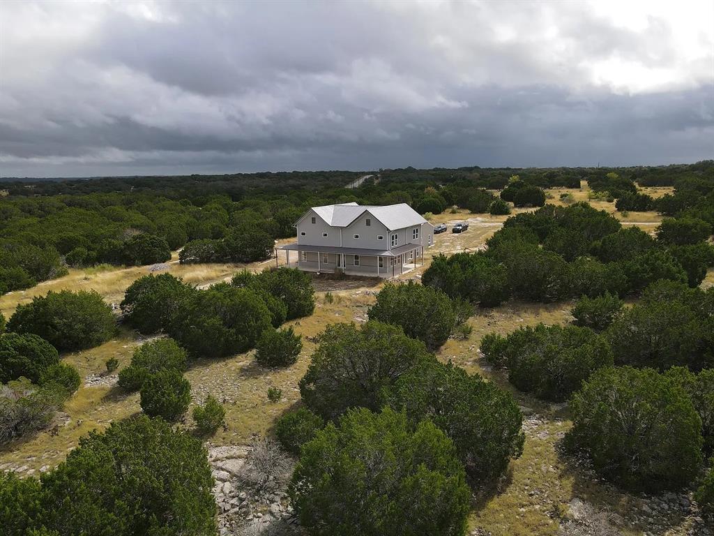 1901 Greystone Ranch Road Bertram, TX 78605 - Photo 9 of 34 an aerial view of a house with a garden
